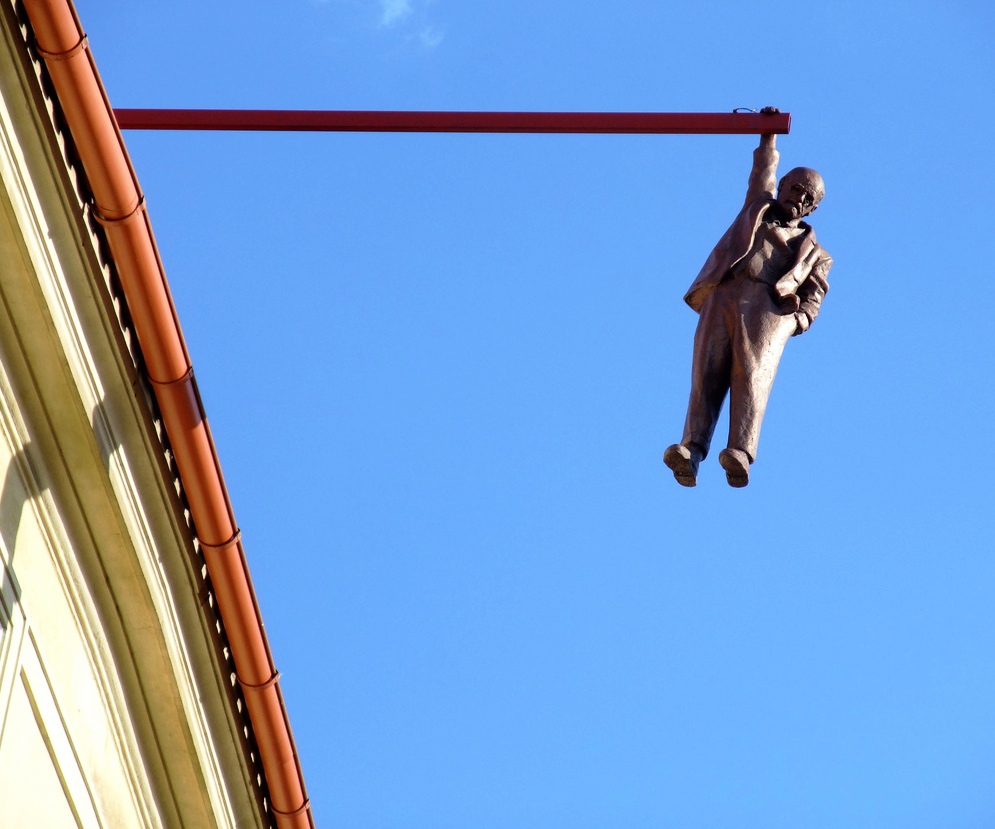 The Statue of a Man hanging by one hand - Amazing sculpture